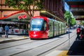 Red light rail running on the track at Capitol Square. Royalty Free Stock Photo